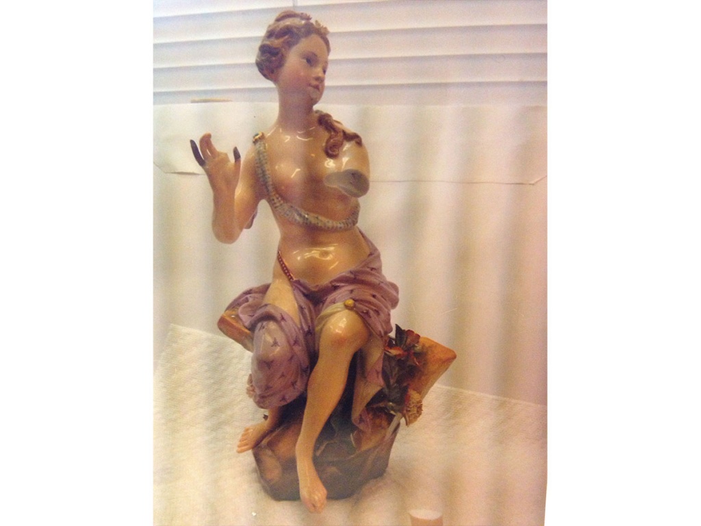 Small porcelain figurine with broken pieces. (Virginia)